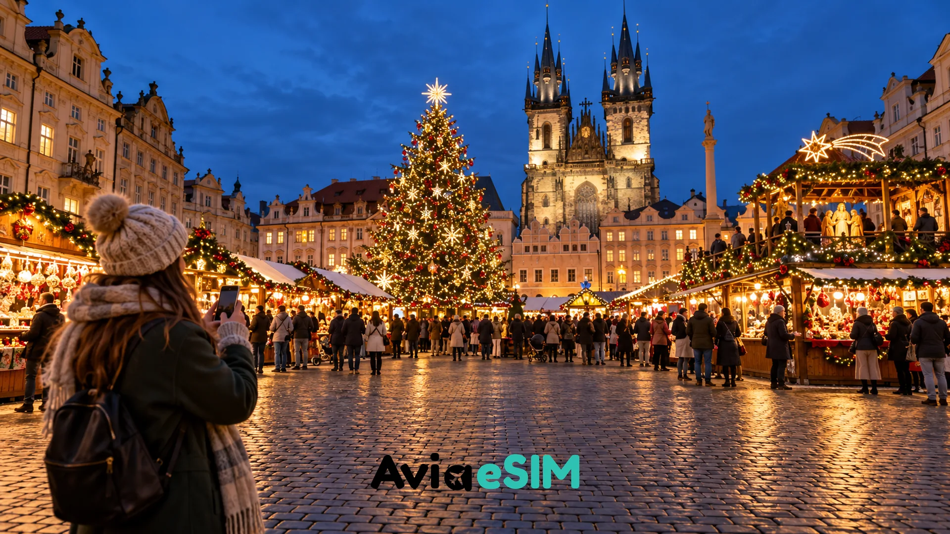 Festive European Christmas market with illuminated stalls and visitors at dusk